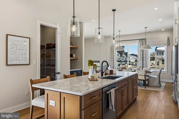 a kitchen with center island table and chairs