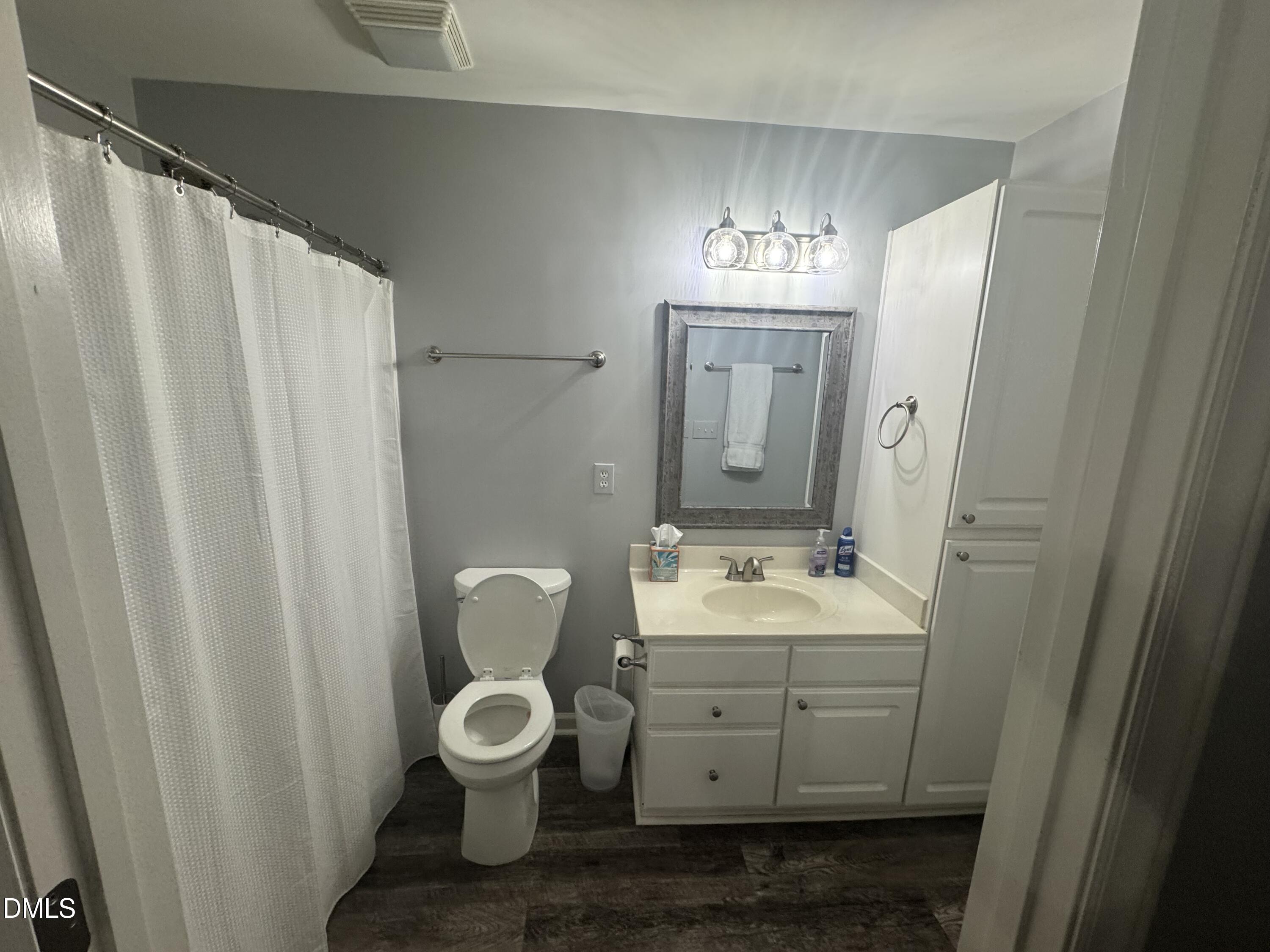 11351 Clubhaven Place, Unit 100 Raleigh, NC 27617 - Photo 25 of 29 a bathroom with a toilet sink and mirror