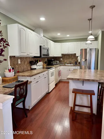 a kitchen with a table chairs stove and cabinets