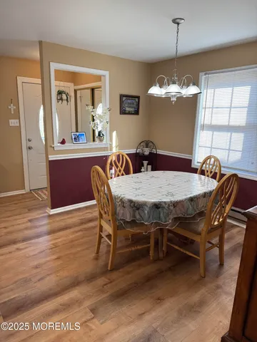 a living room with furniture a chandelier and a couch