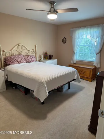 a bedroom with bed and window