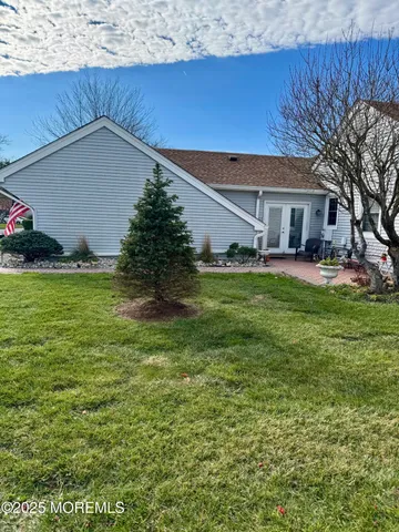 a backyard of a house with yard and outdoor seating