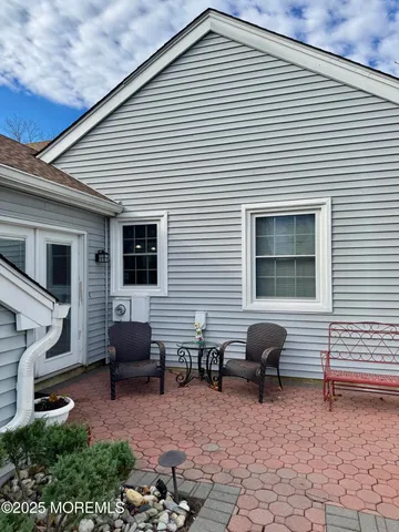 a living room with a baby crib furniture and a flat screen tv