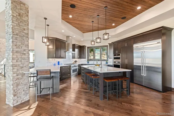 a large kitchen with a table and chairs in it