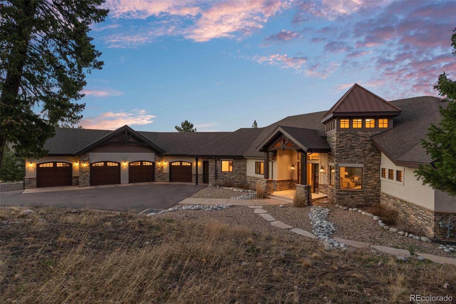 3344 Timbergate Trail Evergreen, CO 80439 - Photo 2 of 50 a front view of a house with a yard and garage