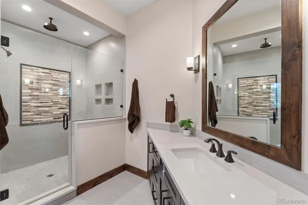 a spacious bathroom with double vanity and a mirror