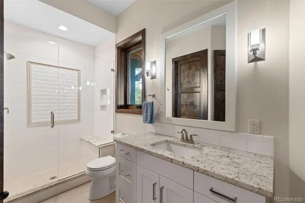 a spacious bedroom with a bed and a chandelier