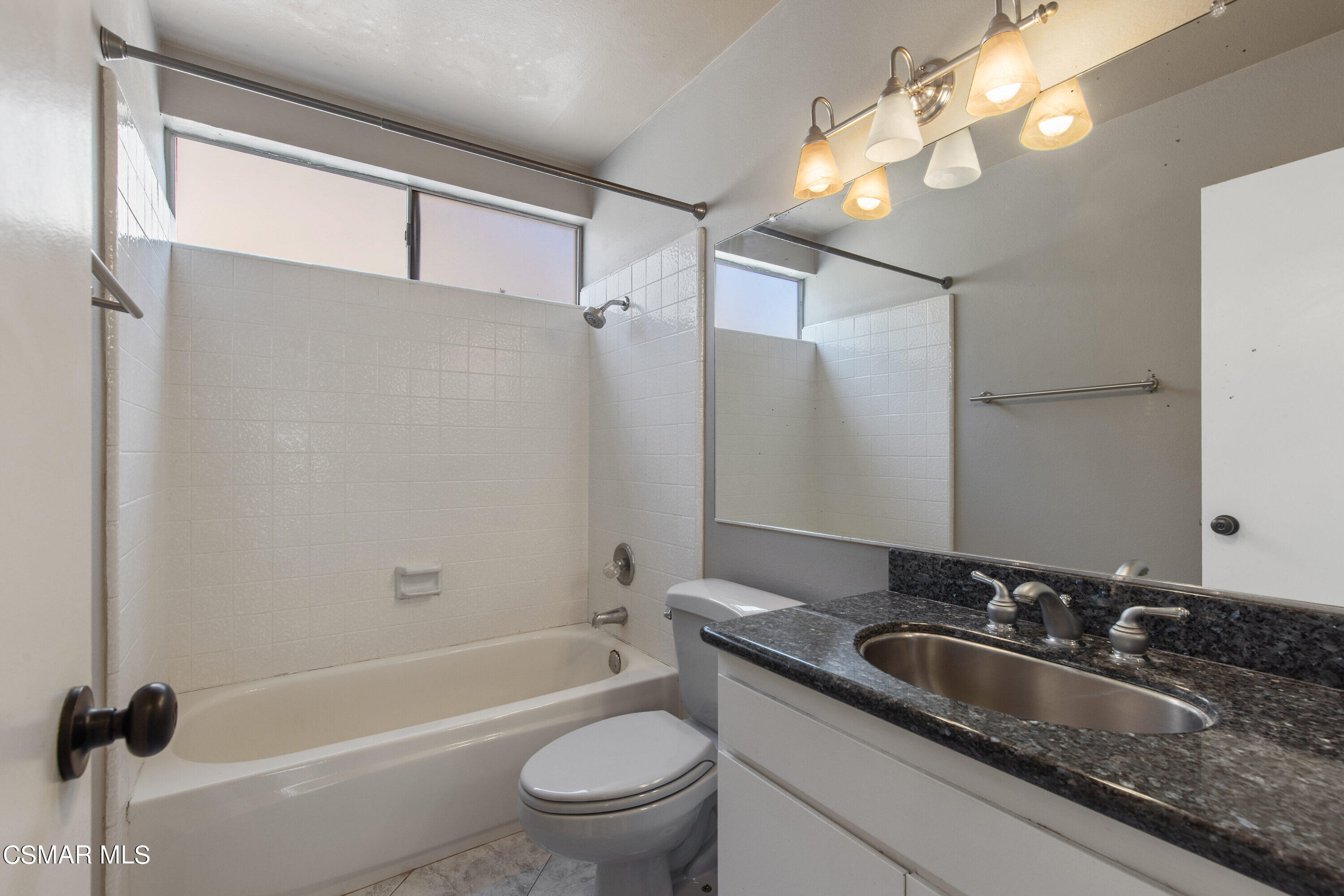 4262 Tecolote Court Moorpark, CA 93021 - Photo 14 of 32 a bathroom with a granite countertop sink a toilet and shower