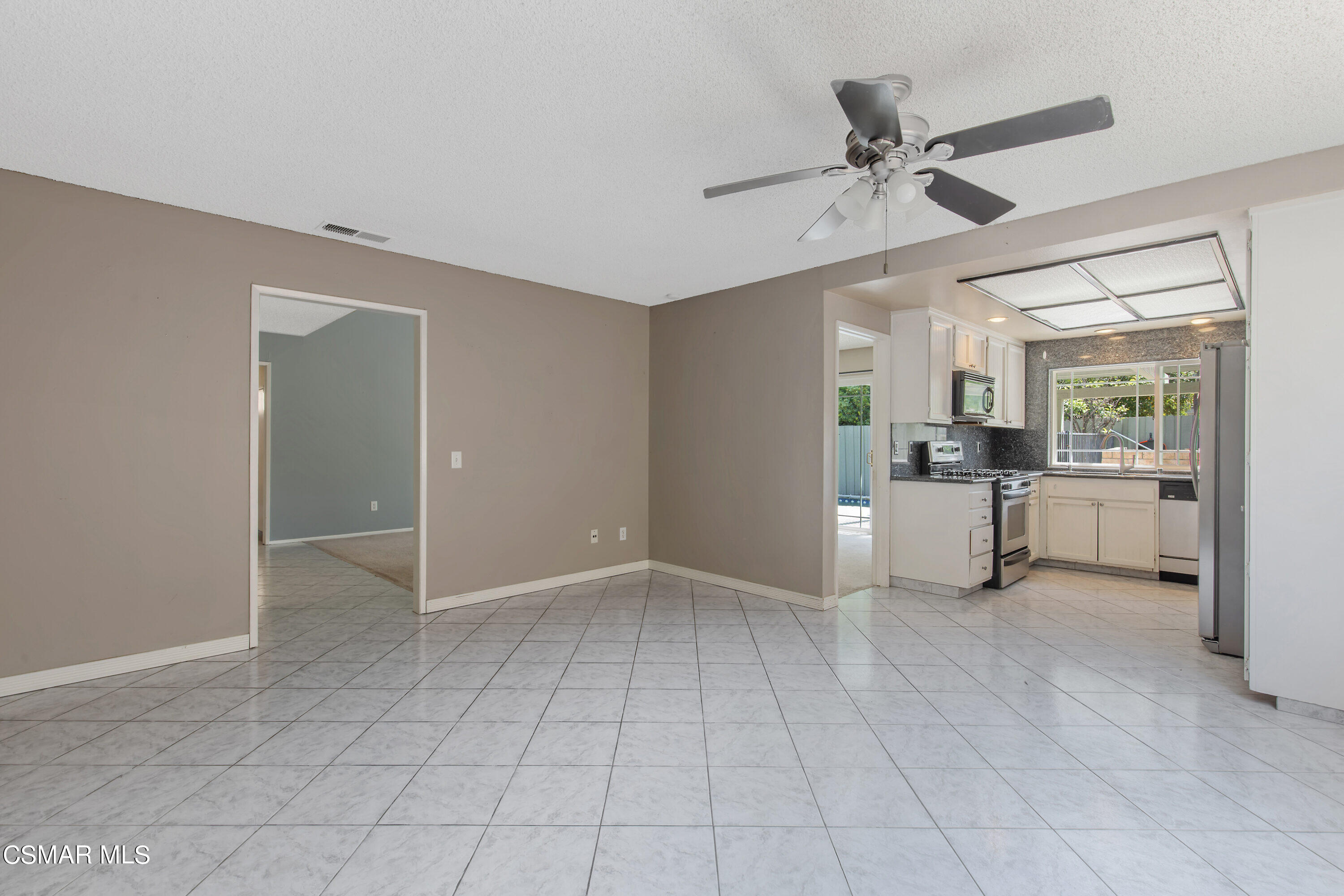 4262 Tecolote Court Moorpark, CA 93021 - Photo 6 of 32 a view of a kitchen with a sink and dishwasher cabinet a fireplace