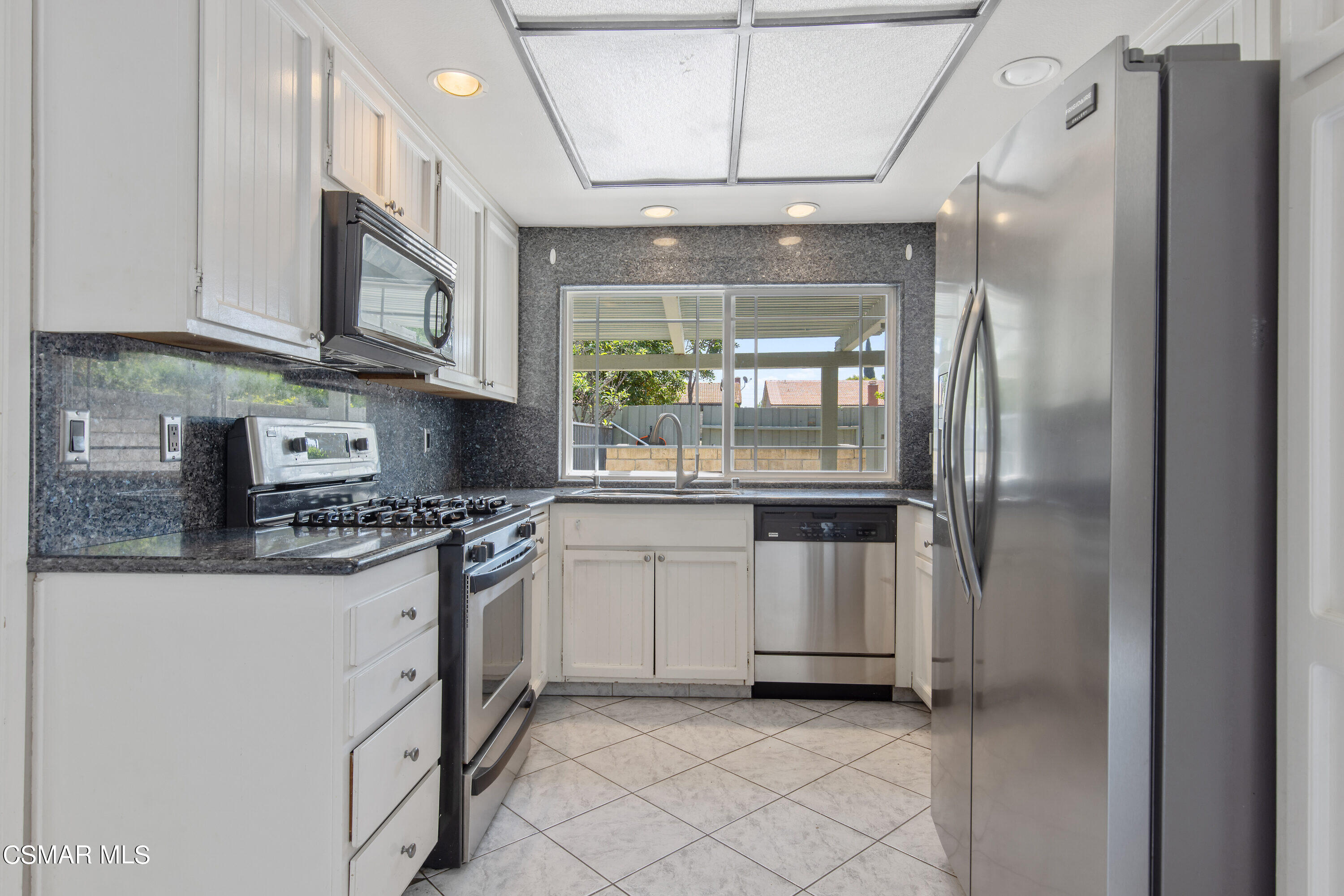 4262 Tecolote Court Moorpark, CA 93021 - Photo 8 of 32 a kitchen with stainless steel appliances granite countertop a refrigerator a stove and a sink