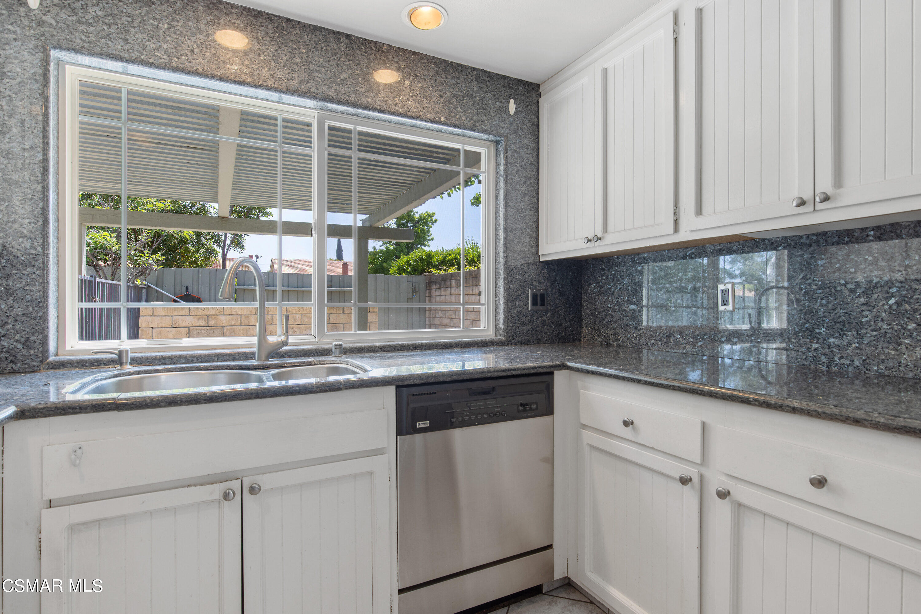 4262 Tecolote Court Moorpark, CA 93021 - Photo 10 of 32 a kitchen with granite countertop white cabinets and a window