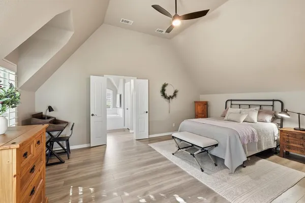 a bedroom with a bed and a table in it