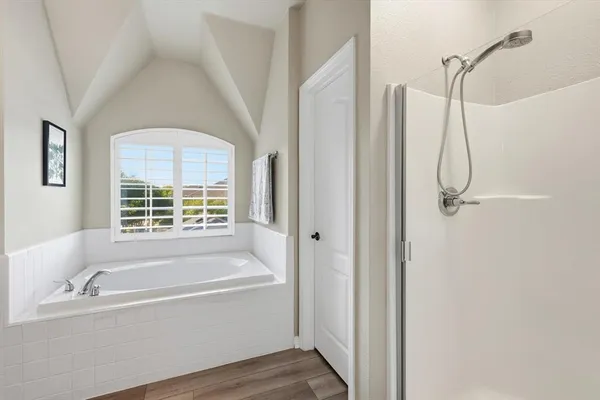 a bathroom with a bathtub and shower