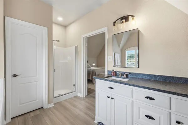 a bathroom with a double vanity sink and mirror
