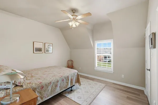 a bedroom with a large bed and a window