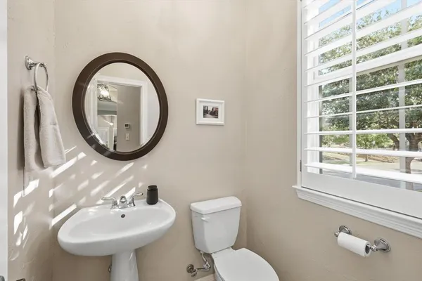 a bathroom with a toilet sink and mirror