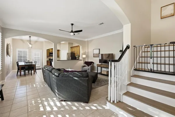 a living room with furniture and a chandelier