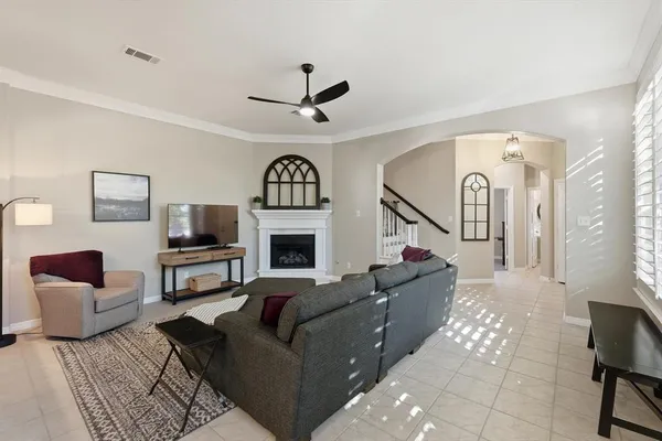 a living room with furniture a fireplace and a flat screen tv