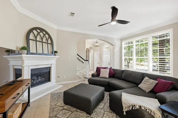 a living room with furniture a fireplace and a large window
