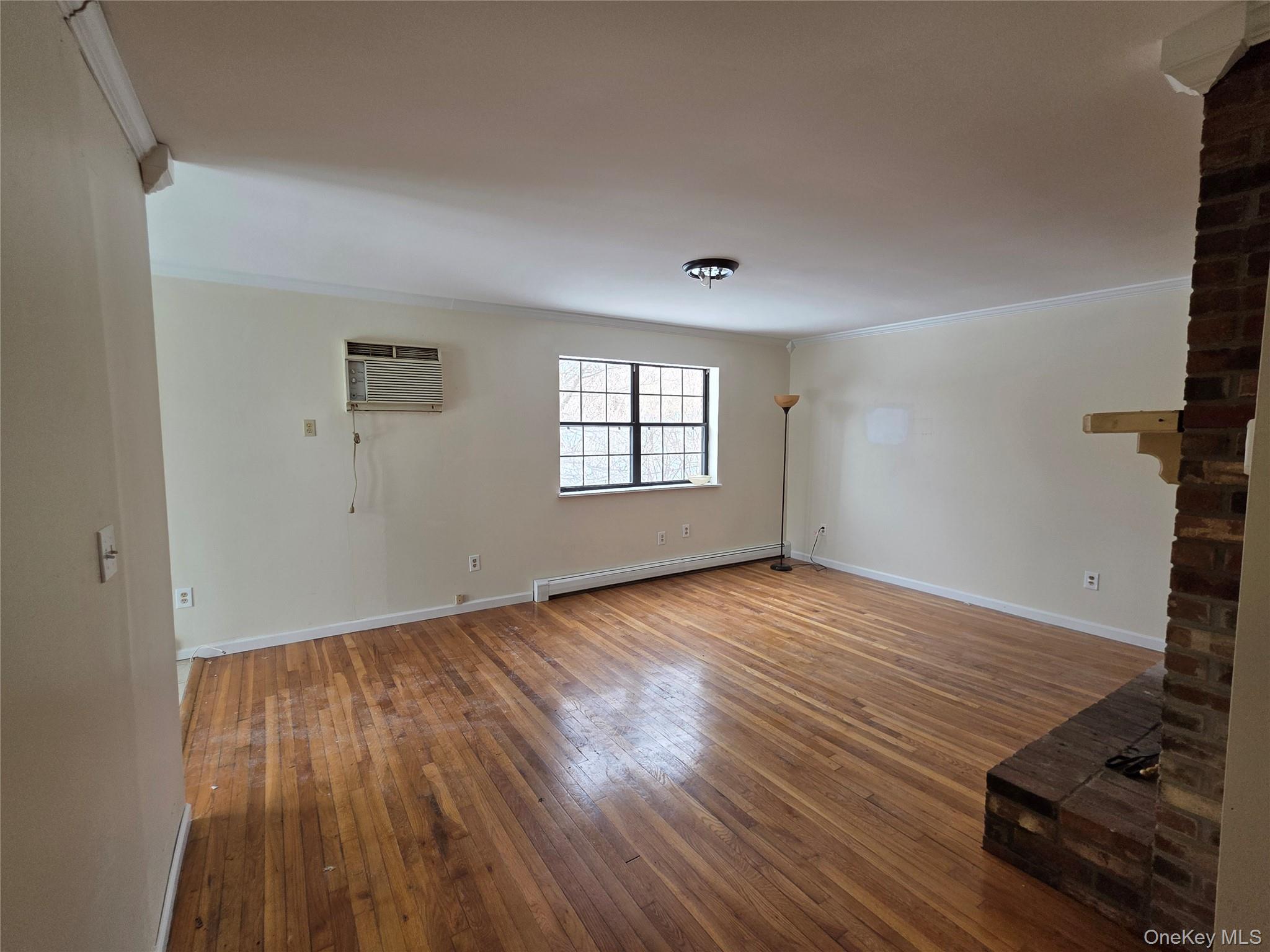 234 Prospect Road, Unit 2 Monroe, NY 10950 - Photo 12 of 19 an empty room with wooden floor and windows