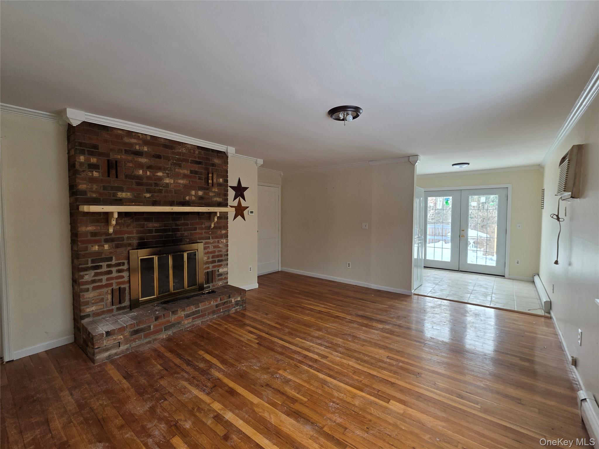234 Prospect Road, Unit 2 Monroe, NY 10950 - Photo 14 of 19 a view of an empty room with wooden floor and a fireplace