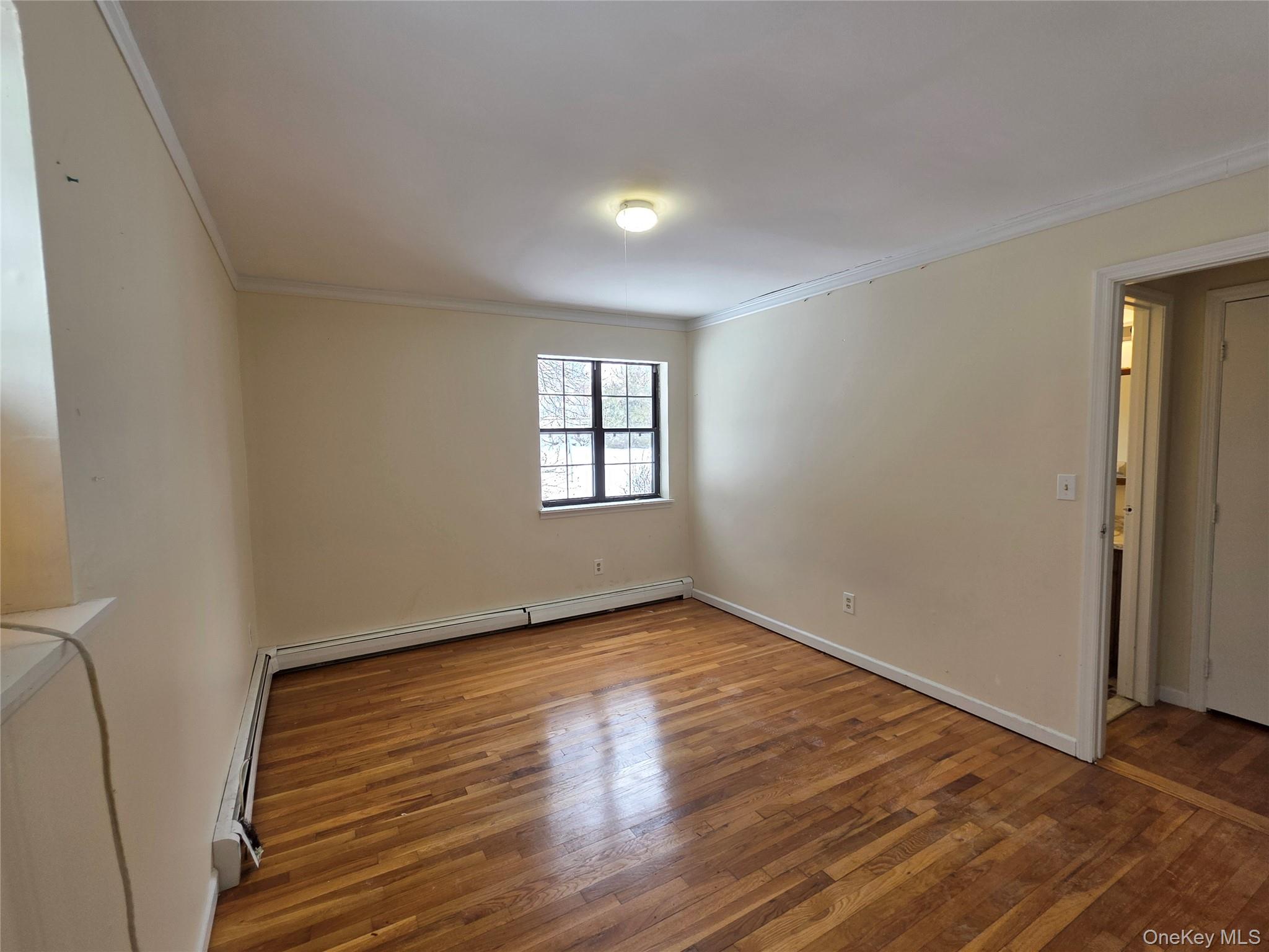 234 Prospect Road, Unit 2 Monroe, NY 10950 - Photo 9 of 19 a view of an empty room with wooden floor and a window