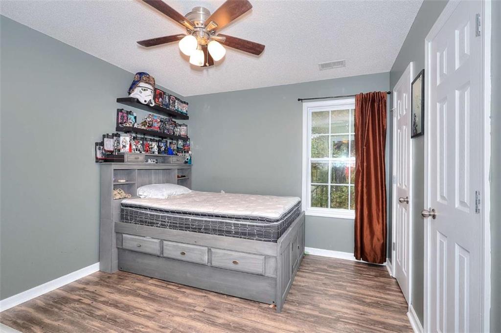 738 Worth Court Bethlehem, GA 30620 - Photo 18 of 43 a room with a chandelier and a dresser