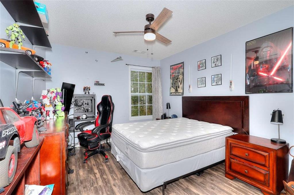 738 Worth Court Bethlehem, GA 30620 - Photo 21 of 43 a bedroom with a bed and a chandelier