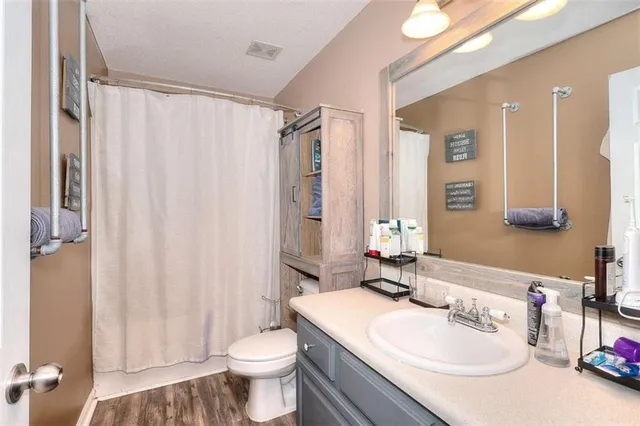 a bathroom with a sink toilet and shower