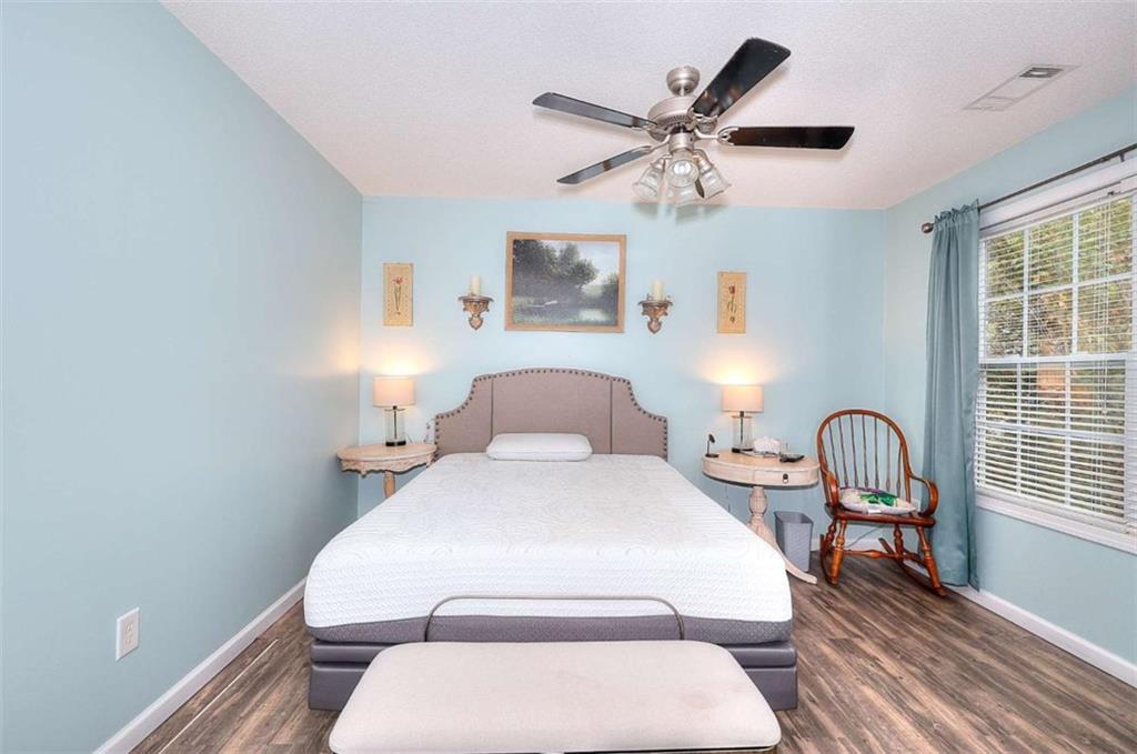 738 Worth Court Bethlehem, GA 30620 - Photo 23 of 43 a bedroom with a bed and wooden floor