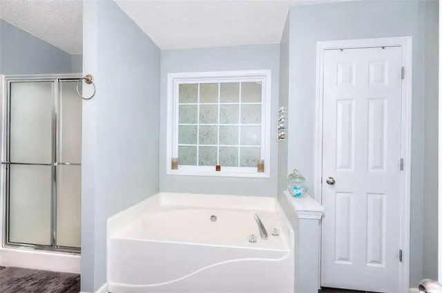 a bathroom with bathtub and shower