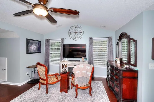 a view of a livingroom with furniture and a flat screen tv