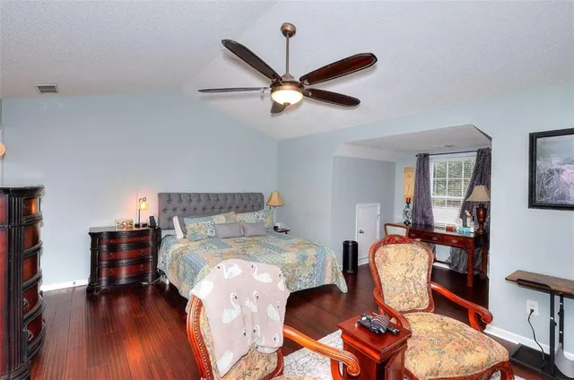 a bed room with bed and chair