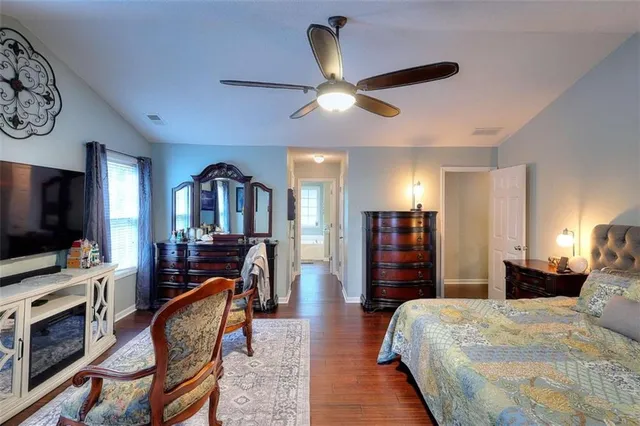 a bedroom with furniture and a flat screen tv