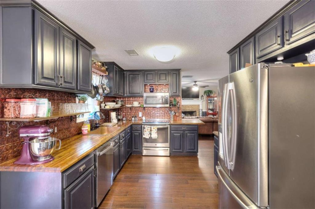 738 Worth Court Bethlehem, GA 30620 - Photo 3 of 43 a kitchen with stainless steel appliances granite countertop a refrigerator a stove top oven a sink and dishwasher