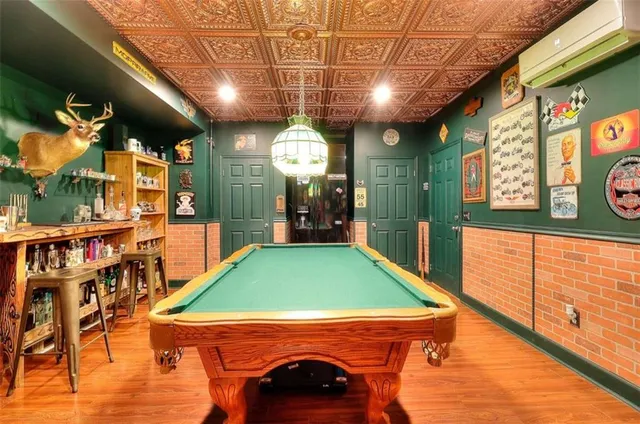 a room with pool pool table and windows