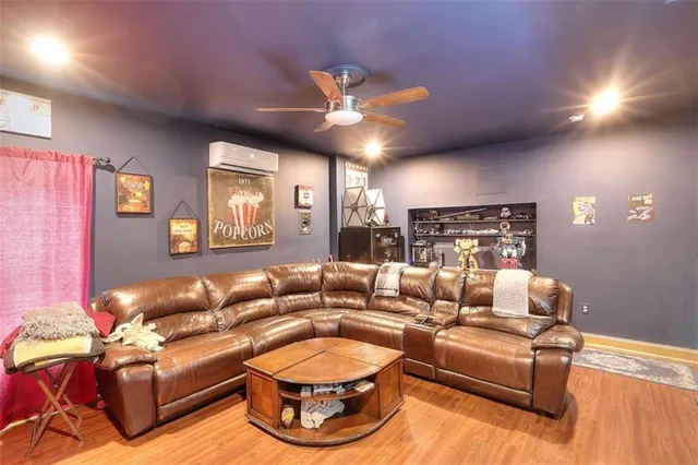 a living room with furniture fireplace and a large window