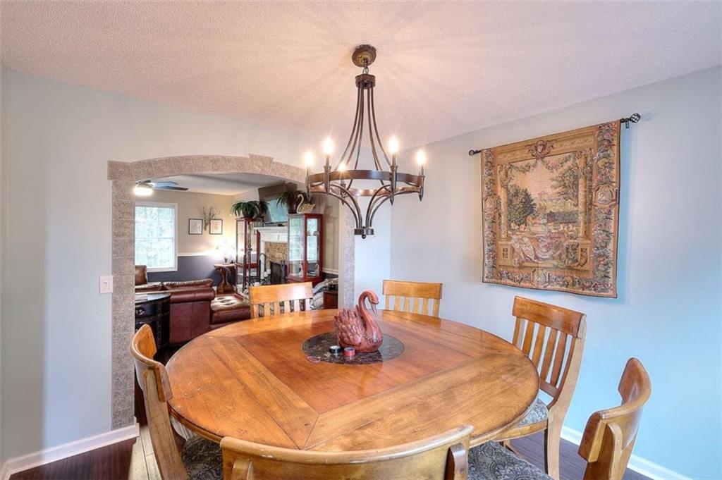 738 Worth Court Bethlehem, GA 30620 - Photo 8 of 43 a view of a dining room with furniture wooden floor and chandelier