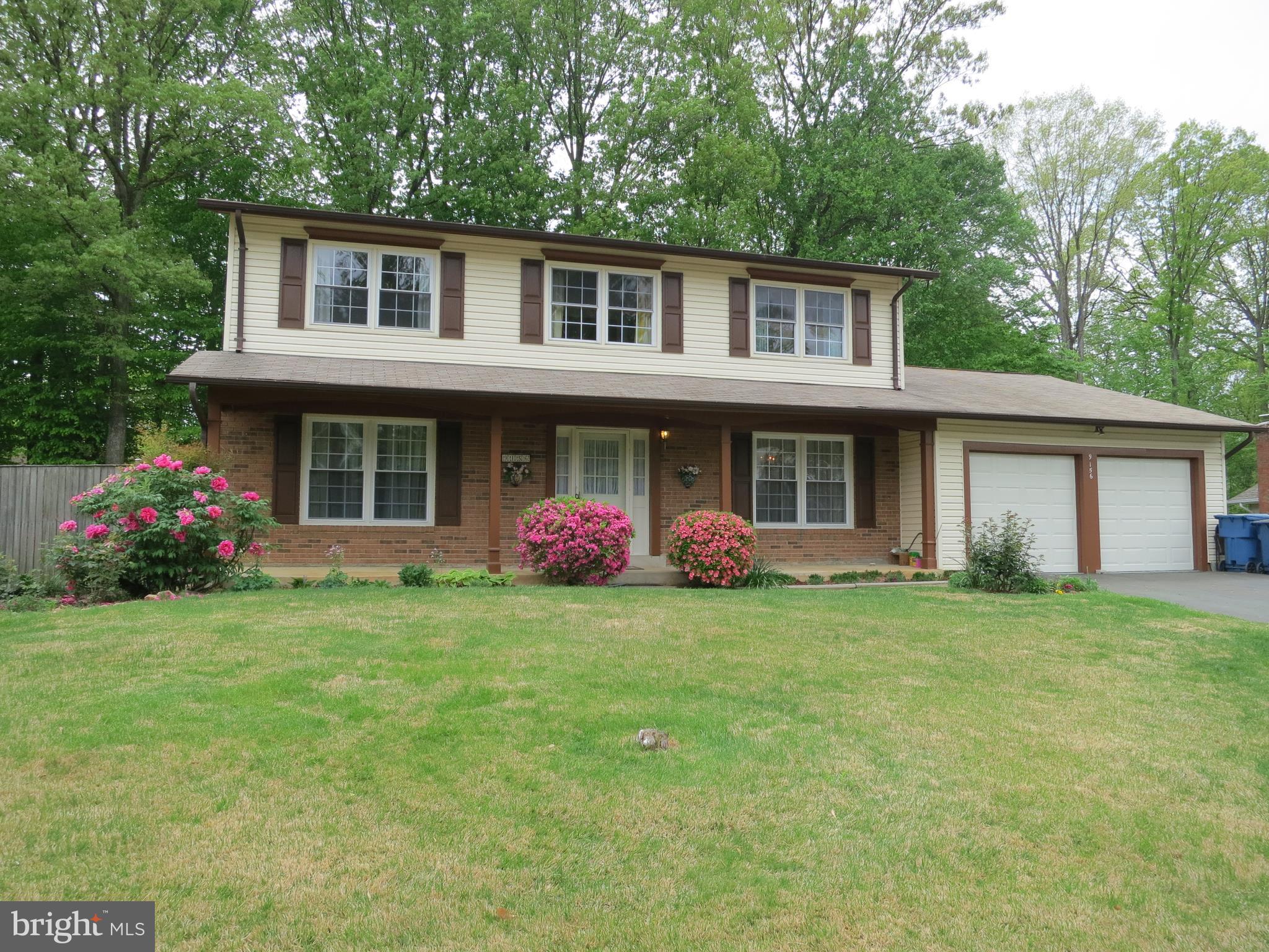 9156 Rockefeller Lane Springfield, VA 22153 - Photo 1 of 30 a front view of a house with a garden