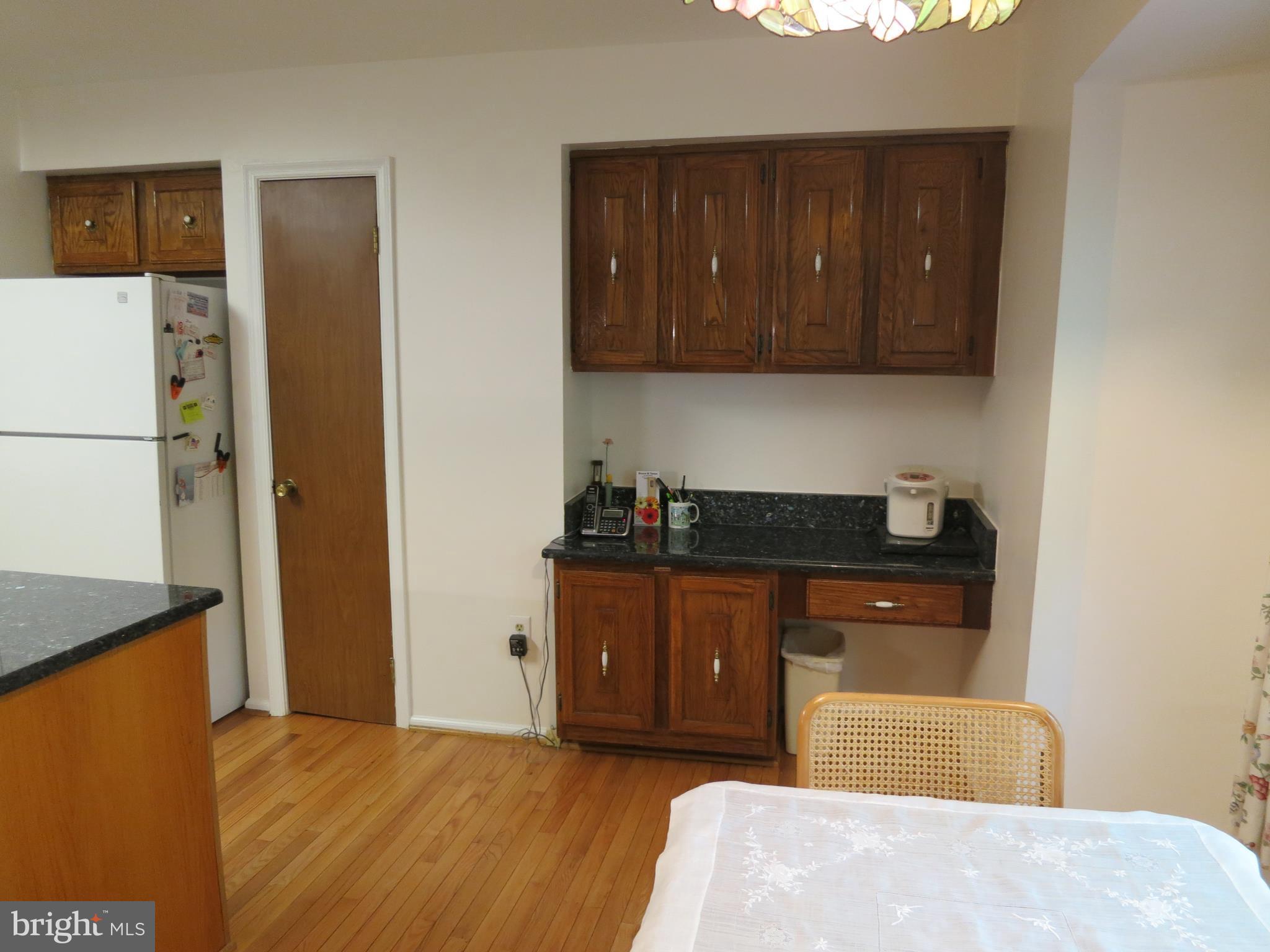 9156 Rockefeller Lane Springfield, VA 22153 - Photo 11 of 30 a bedroom with a bed and wooden cabinets