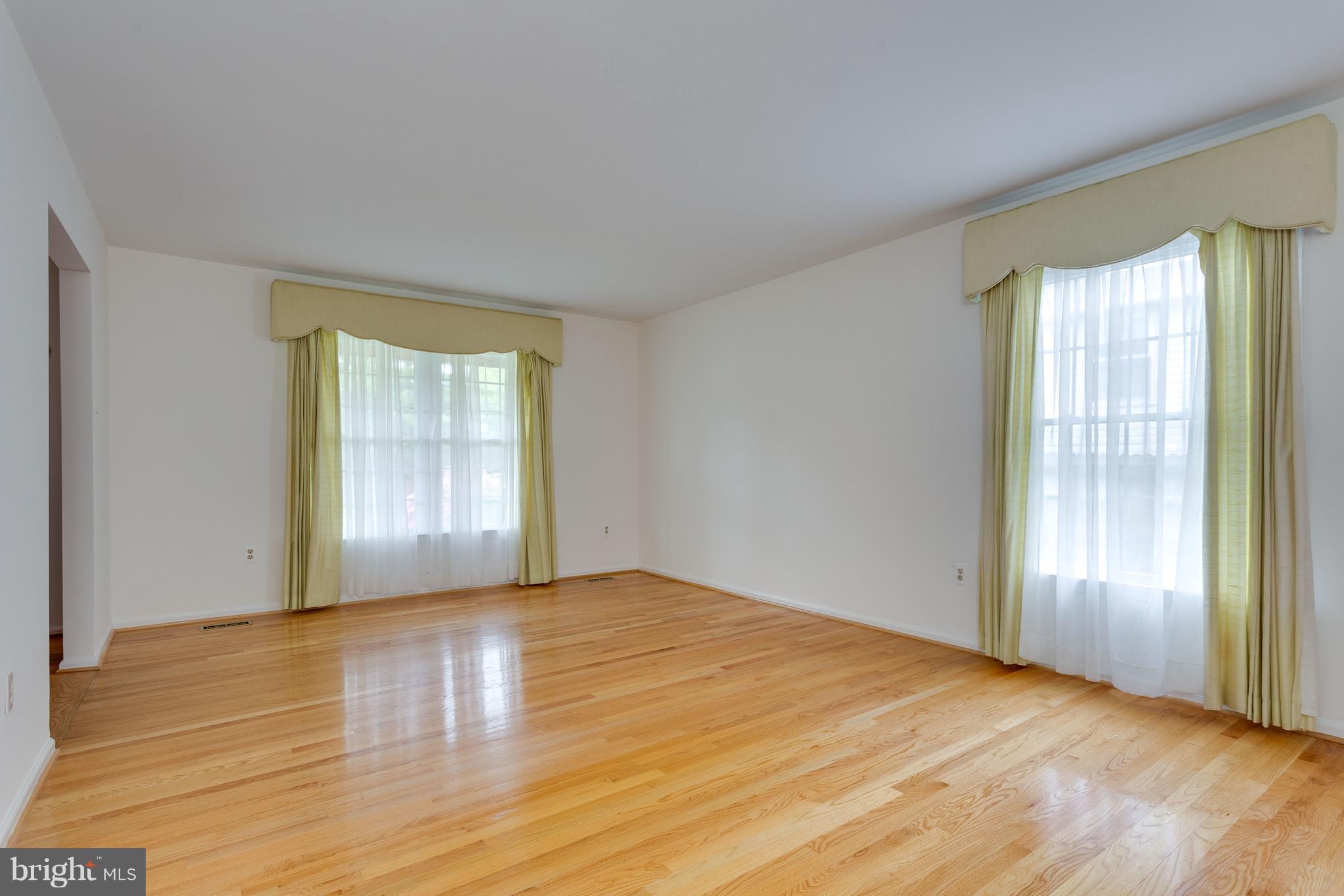 9156 Rockefeller Lane Springfield, VA 22153 - Photo 3 of 30 a view of an empty room with wooden floor and a window
