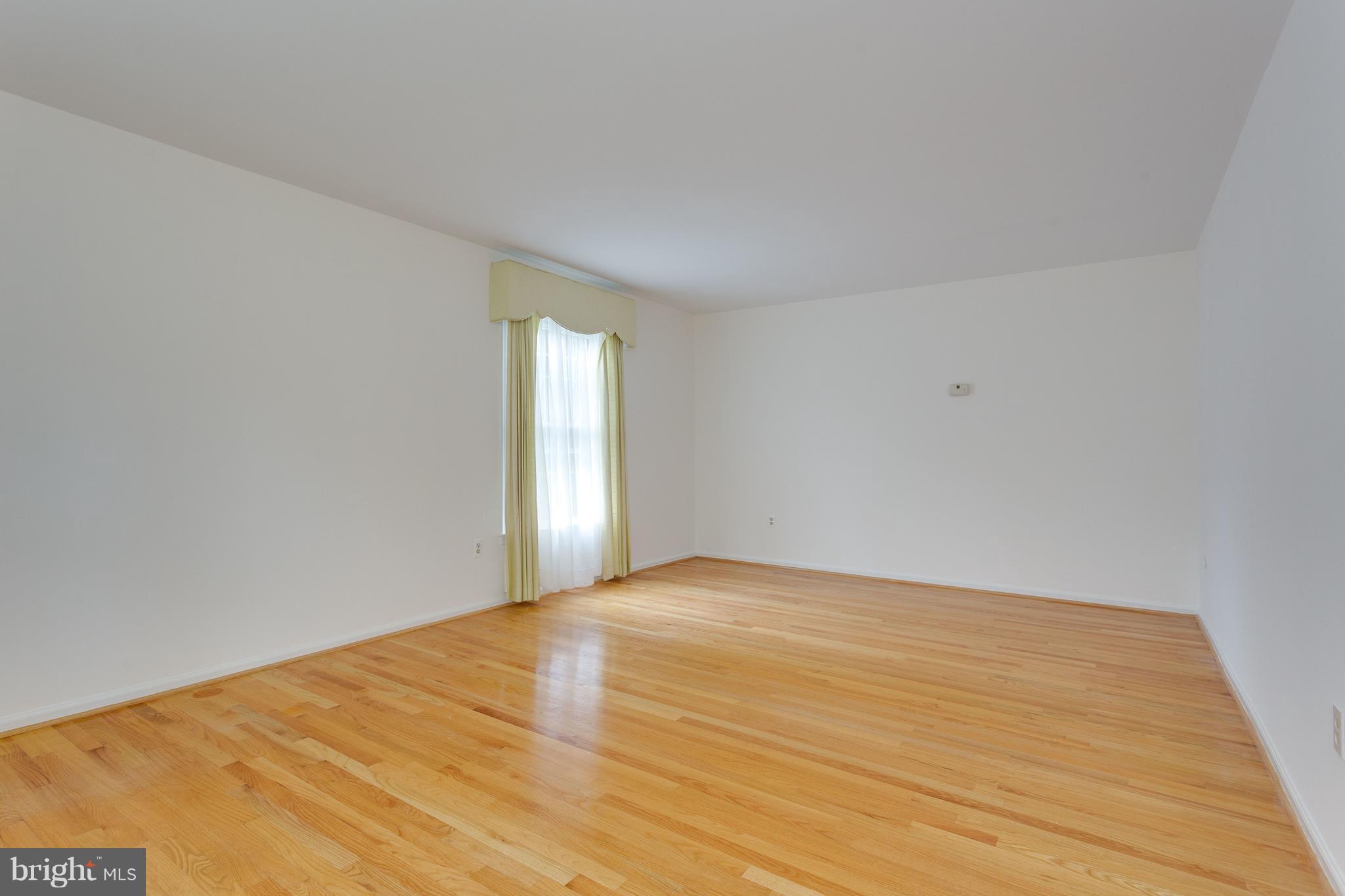 9156 Rockefeller Lane Springfield, VA 22153 - Photo 4 of 30 a view of an empty room and wooden floor