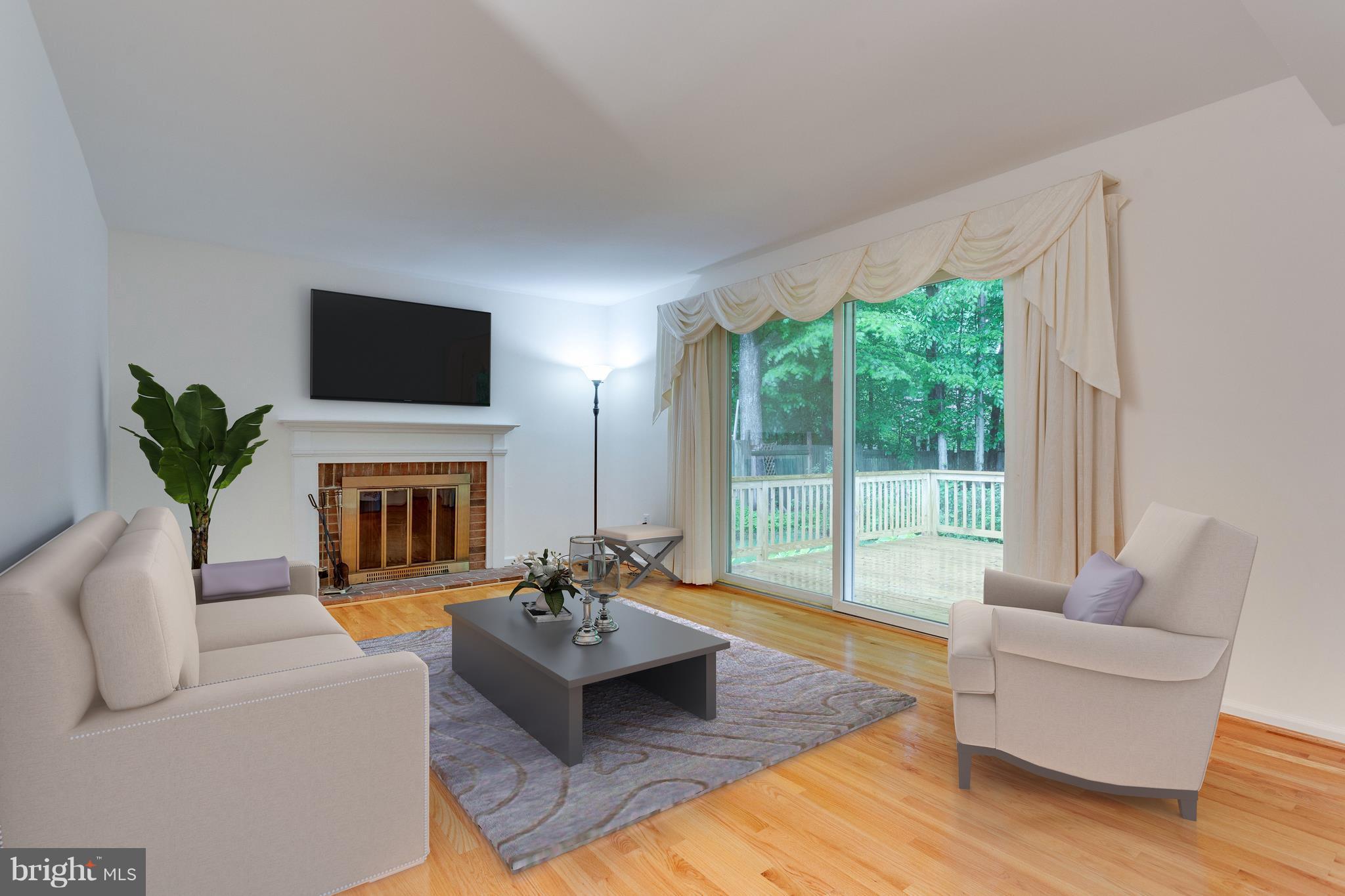 9156 Rockefeller Lane Springfield, VA 22153 - Photo 7 of 30 a living room with furniture a fireplace and a flat screen tv