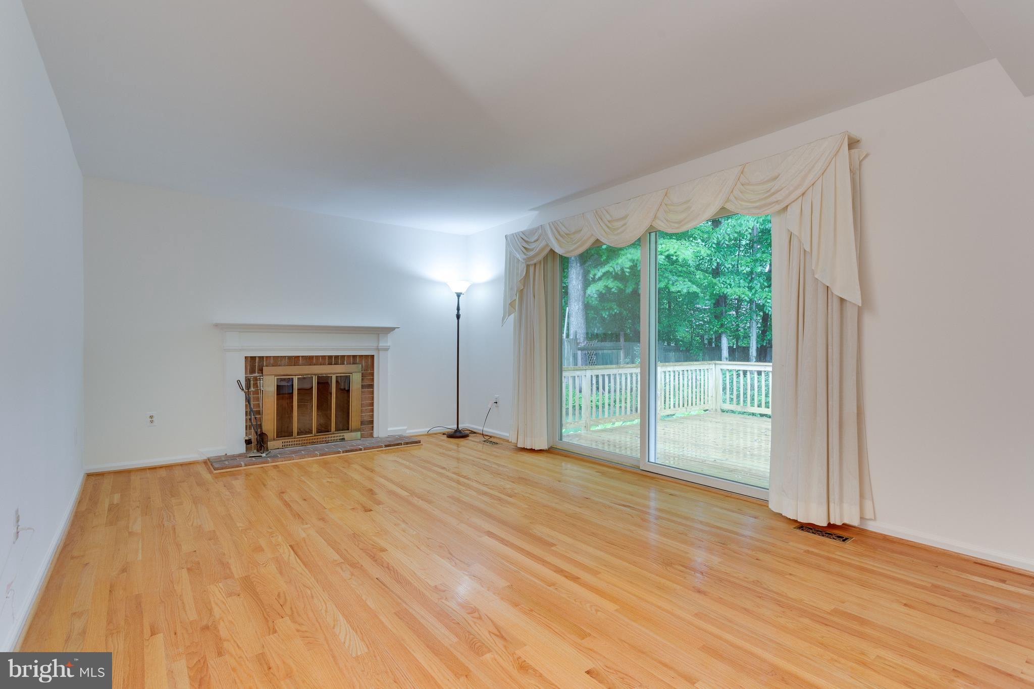 9156 Rockefeller Lane Springfield, VA 22153 - Photo 8 of 30 a big room with wooden floor and windows