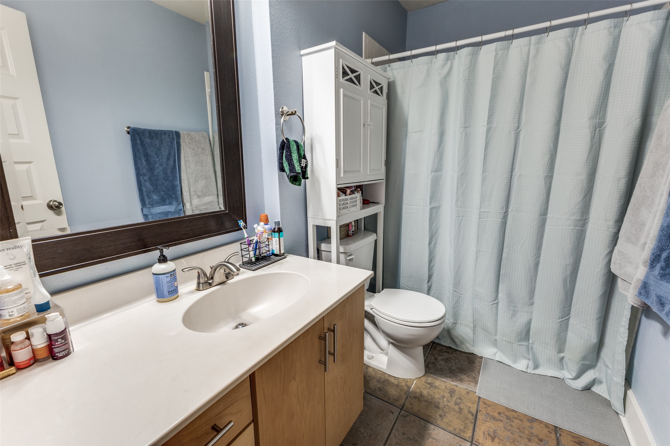 3815 Guadalupe Street, Unit 305 Austin, TX 78751 - Photo 13 of 27 a bathroom with a sink toilet and shower