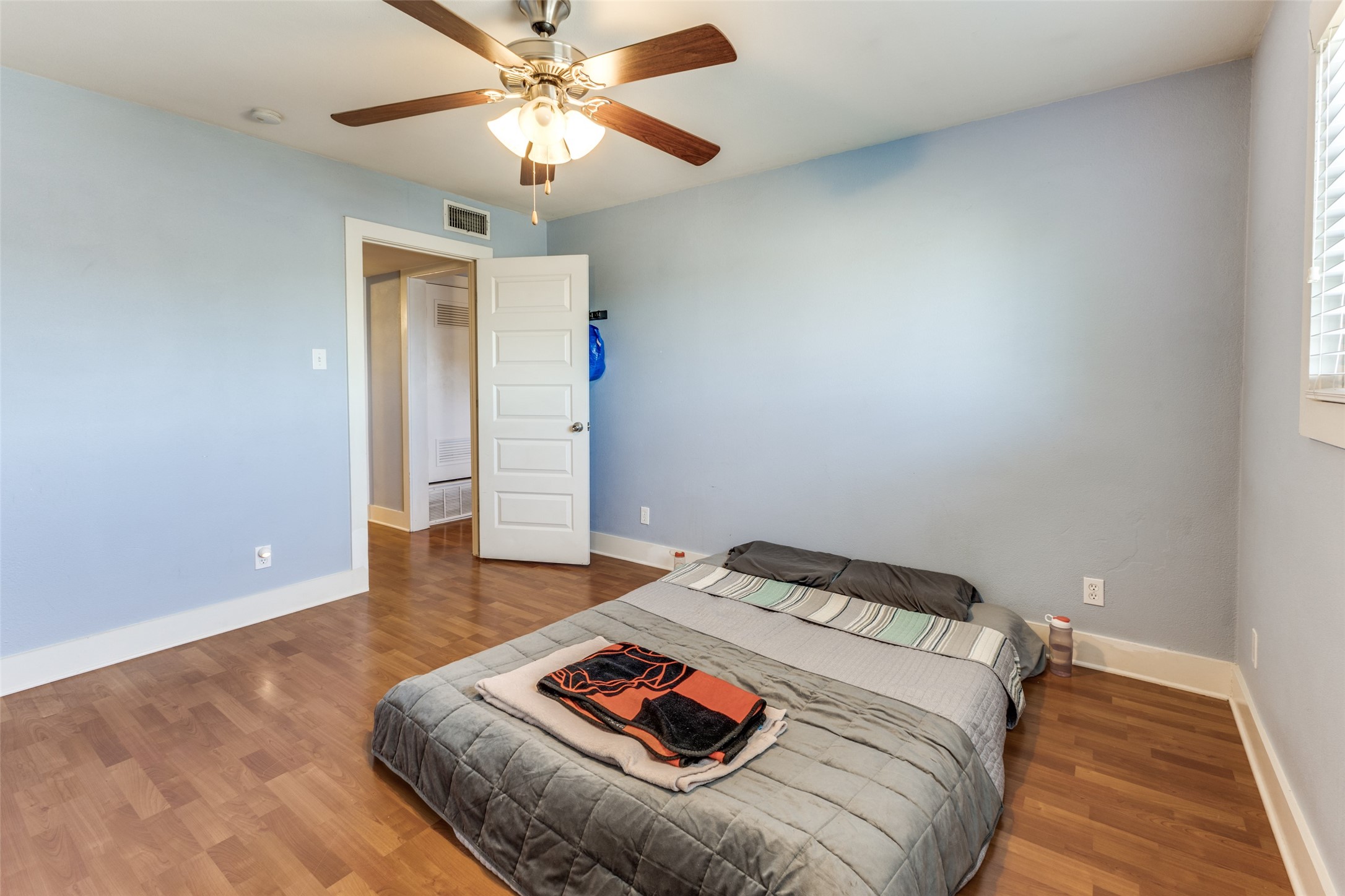 3815 Guadalupe Street, Unit 305 Austin, TX 78751 - Photo 19 of 27 a bedroom with a bed and a chandelier