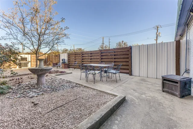 a wooden bench sitting in middle of a yard