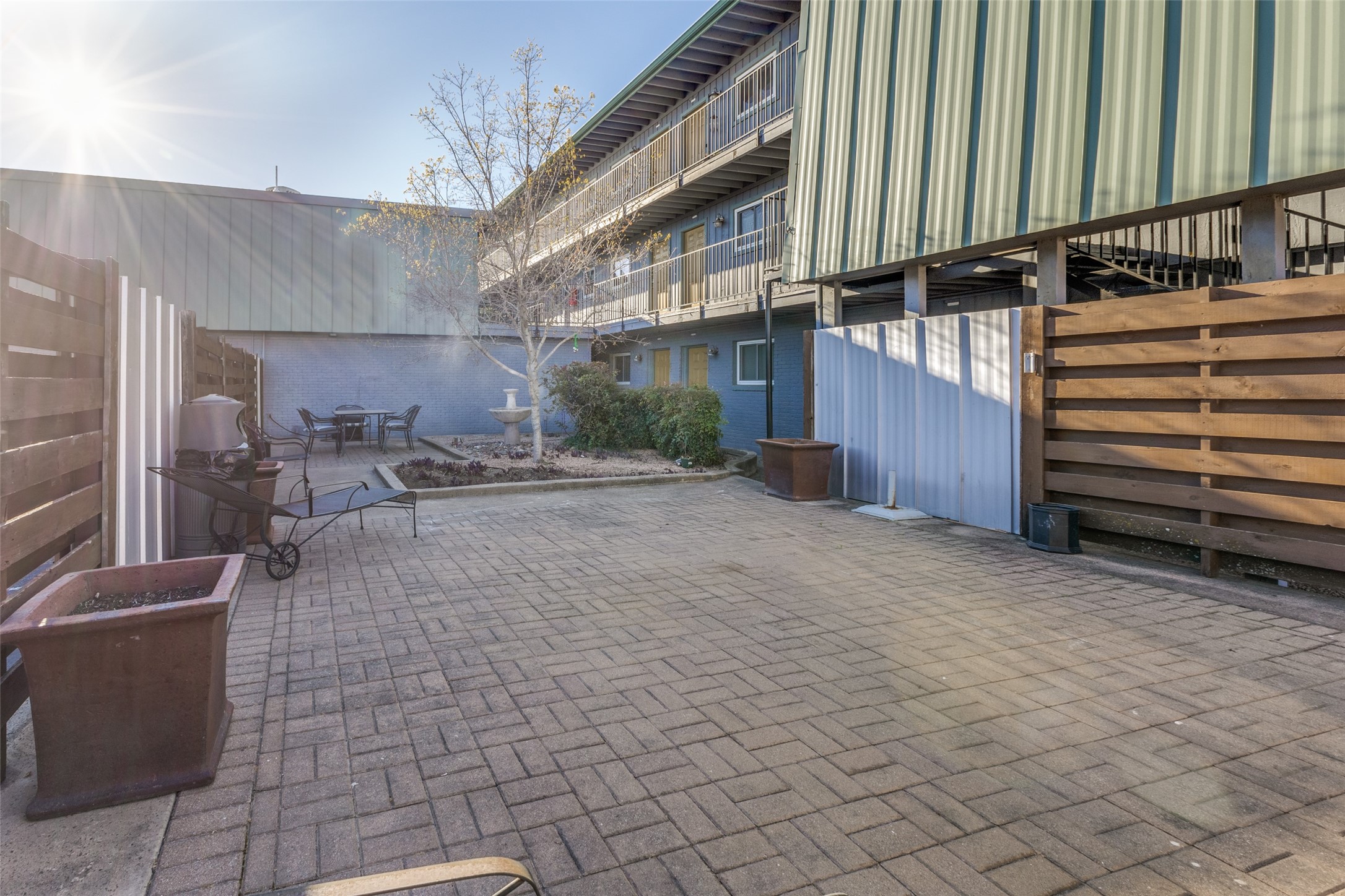 3815 Guadalupe Street, Unit 305 Austin, TX 78751 - Photo 25 of 27 a view of a patio with a table and chairs
