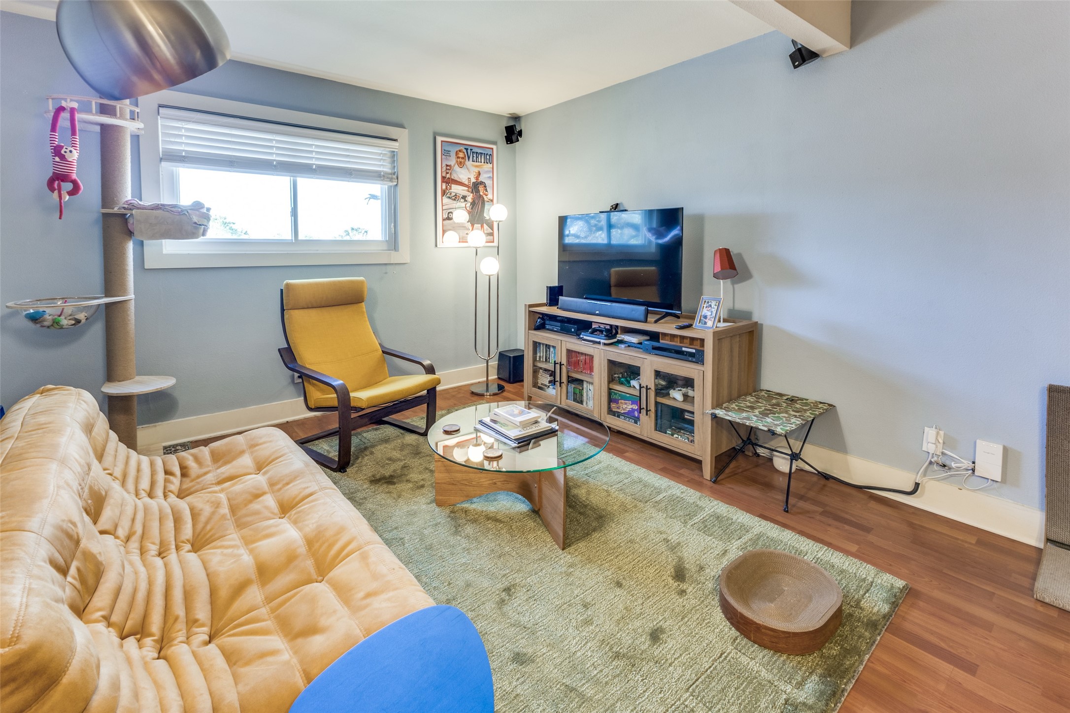3815 Guadalupe Street, Unit 305 Austin, TX 78751 - Photo 4 of 27 a living room with furniture a flat screen tv and a window