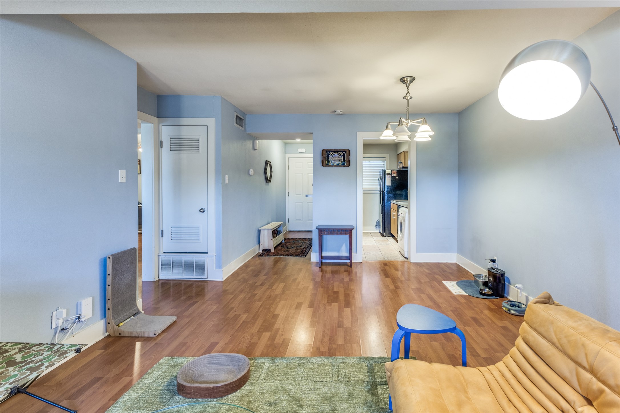 3815 Guadalupe Street, Unit 305 Austin, TX 78751 - Photo 7 of 27 a living room with furniture and a chandelier